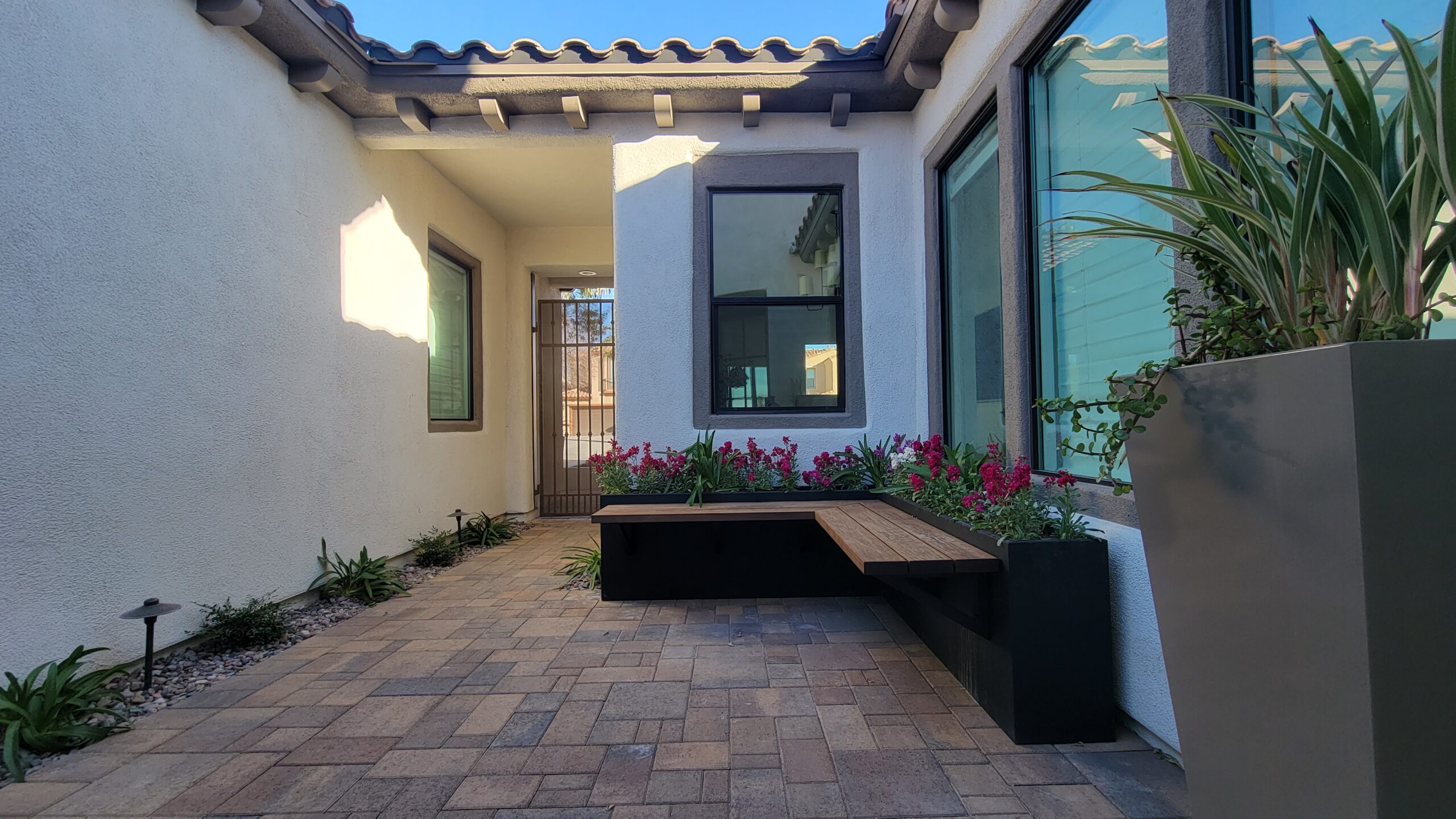 A bench sitting in the middle of a patio.