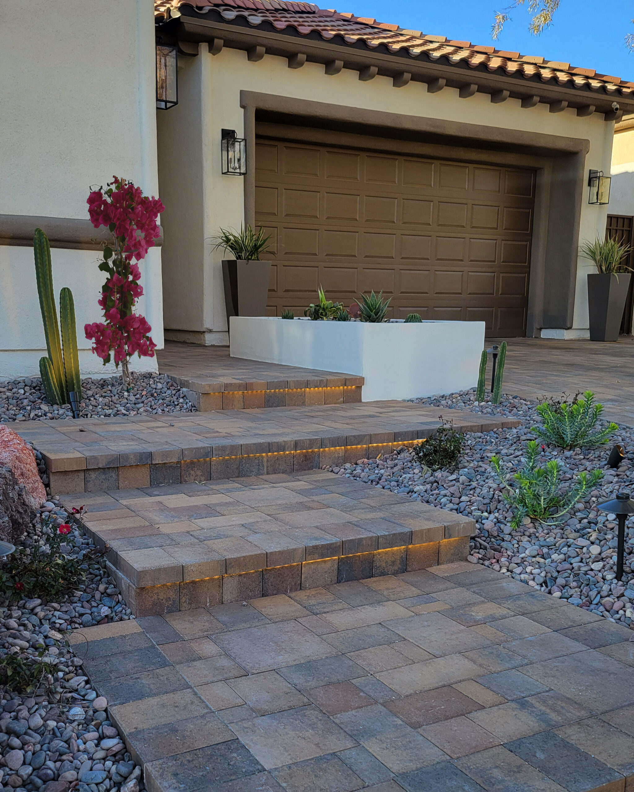 A home with a driveway and steps leading to the garage.