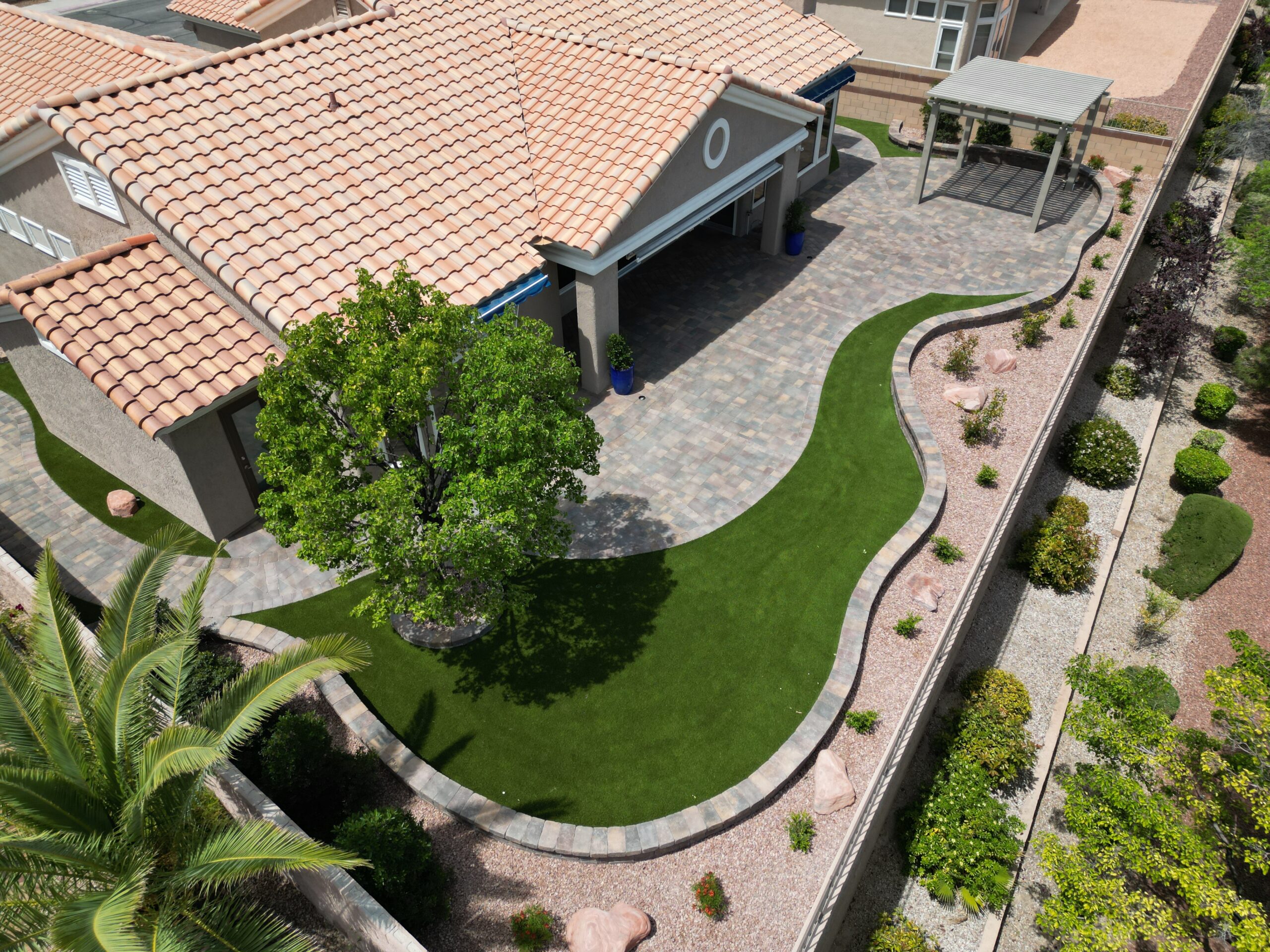 A bird 's eye view of a backyard with a lawn.