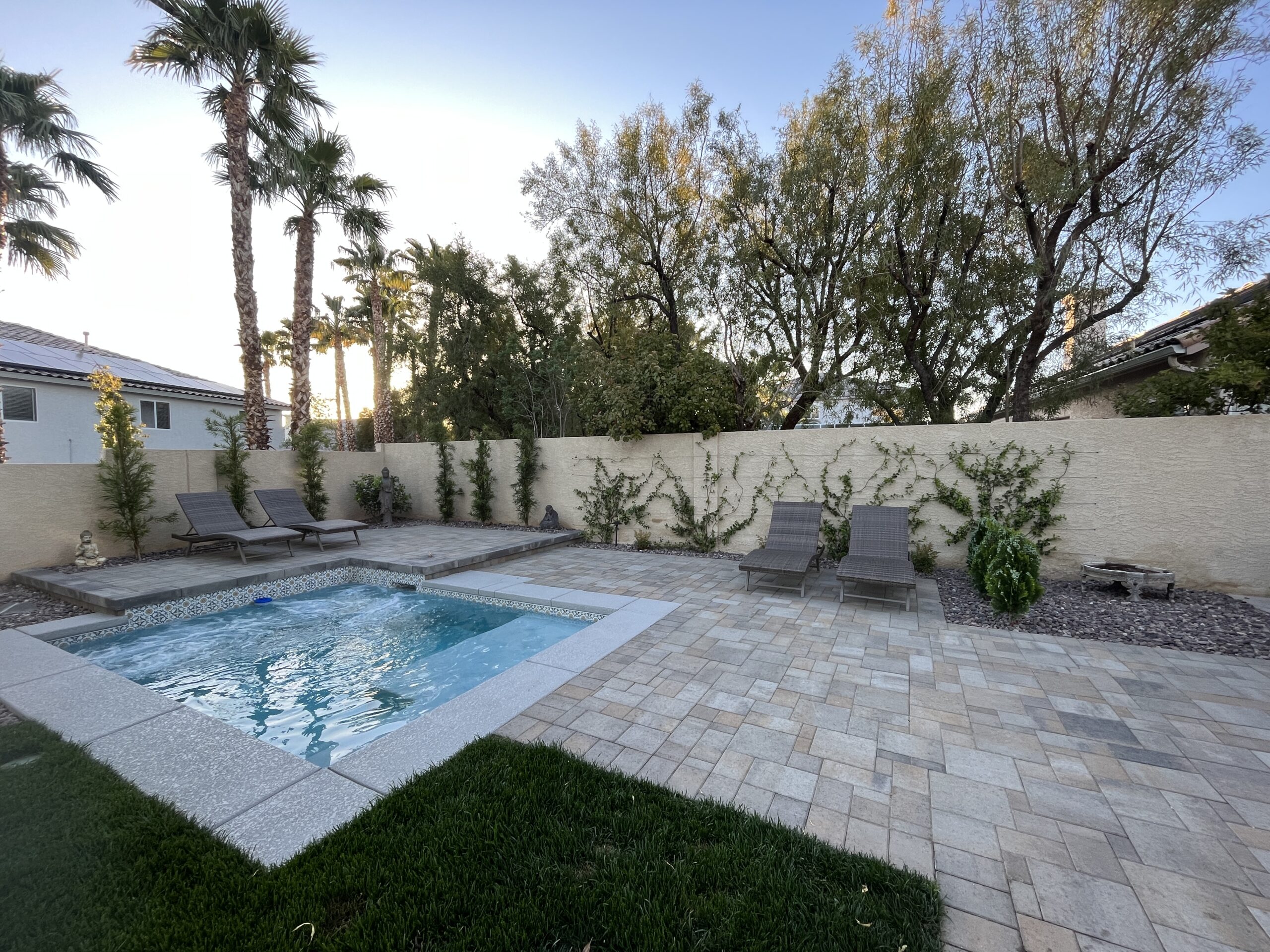 A pool that is in the middle of some grass.