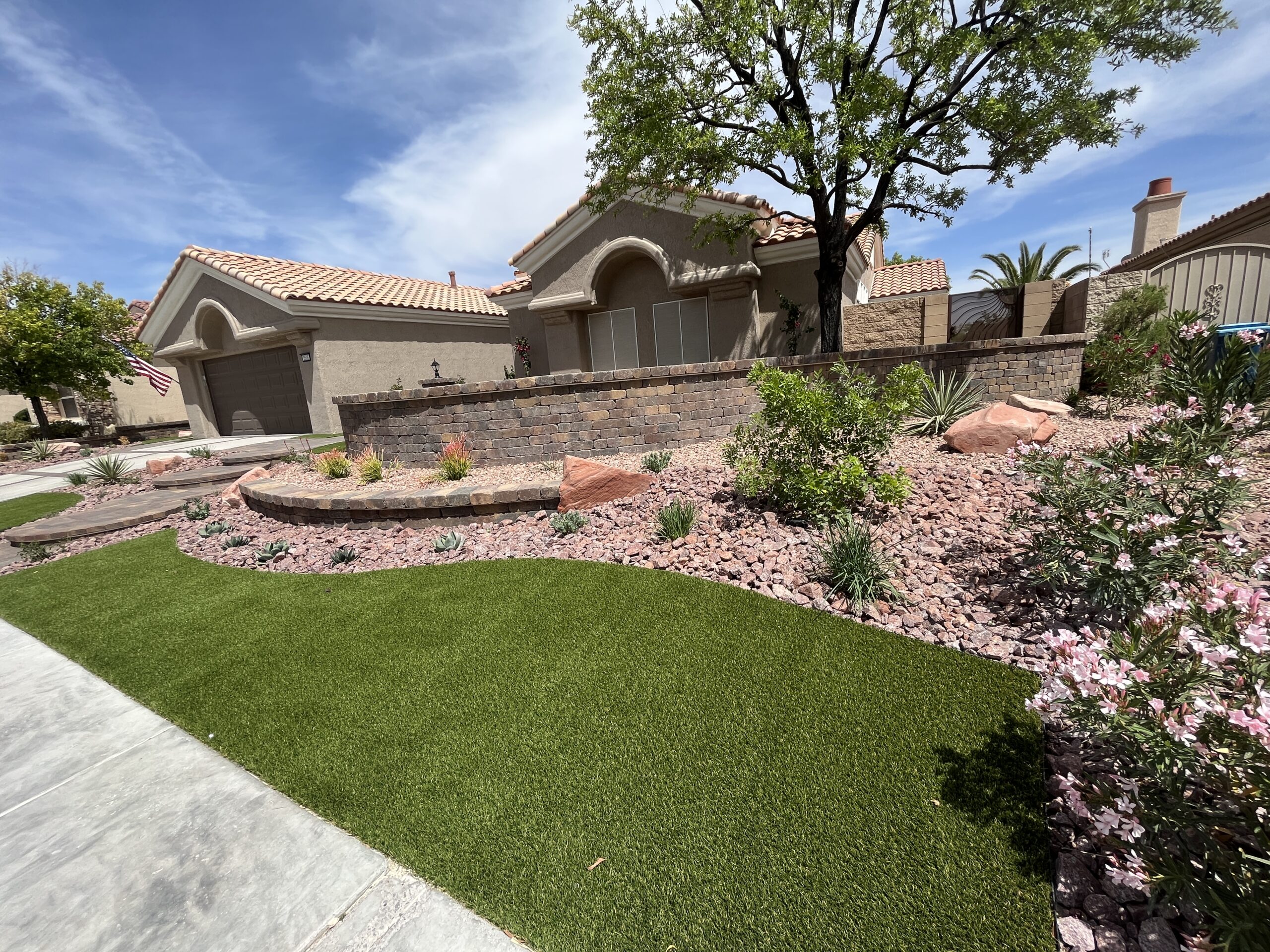 A house with a large lawn and landscaping.