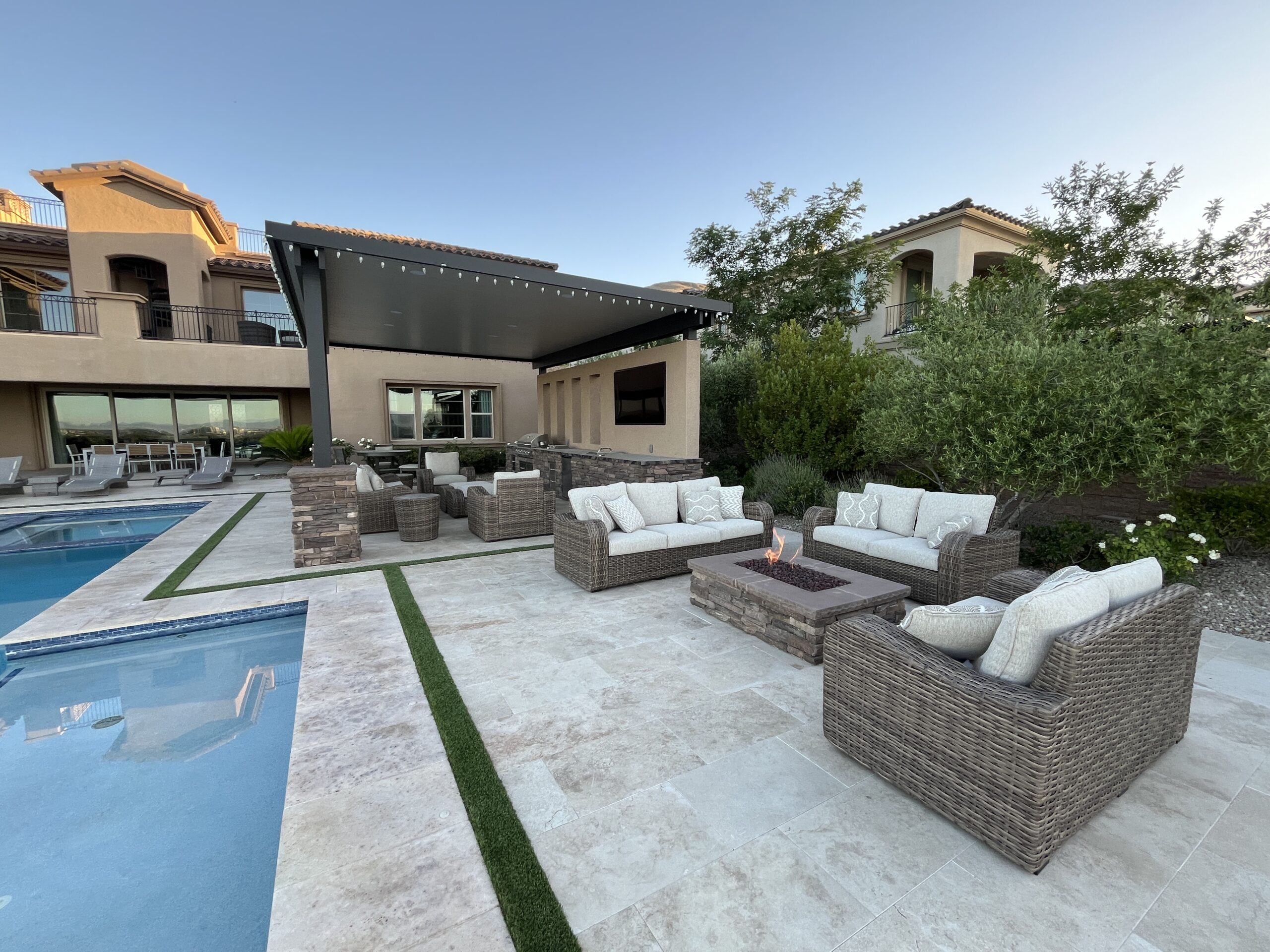 A large backyard with a pool and patio furniture.