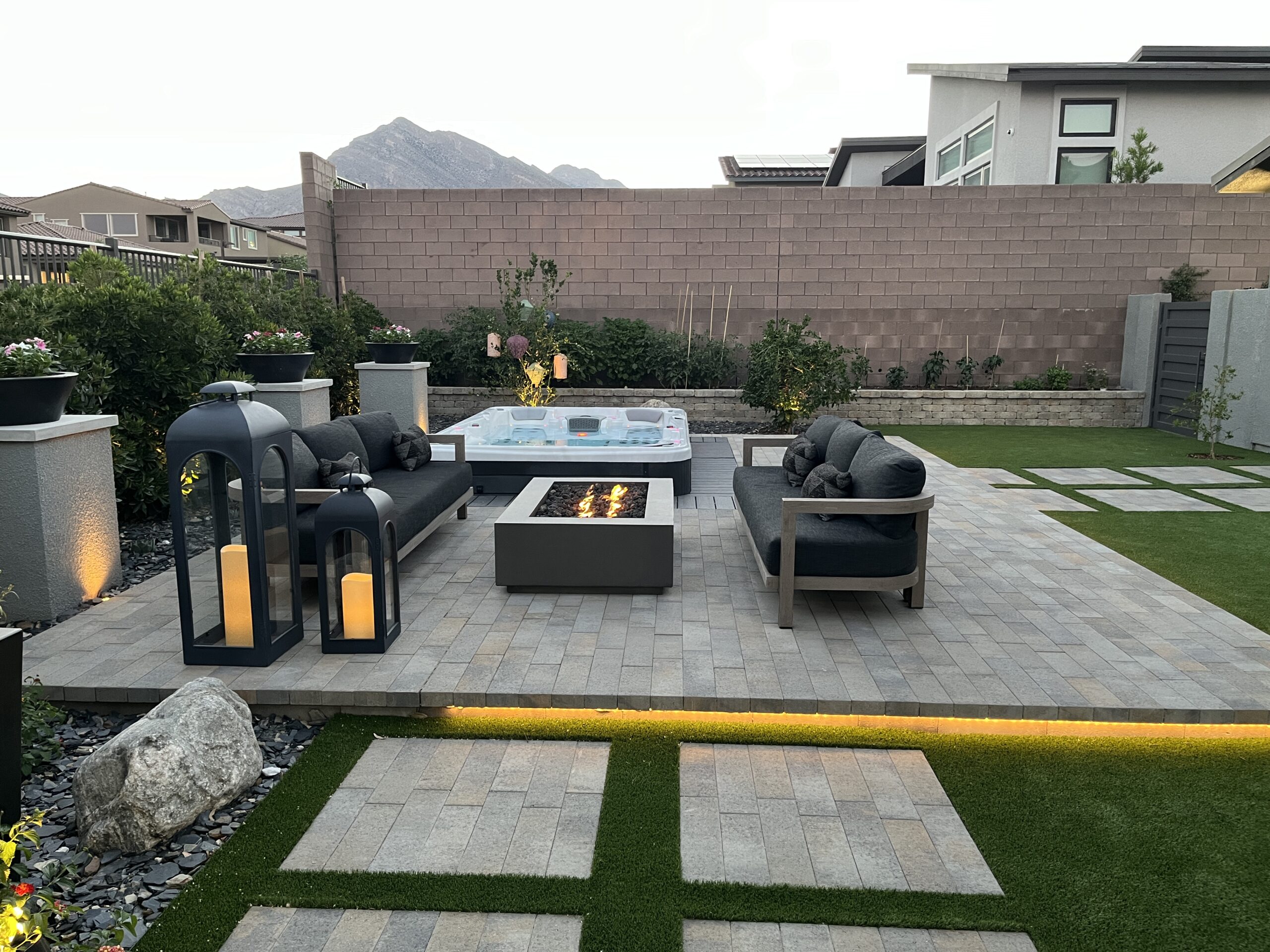 A patio with fire pit and couch set