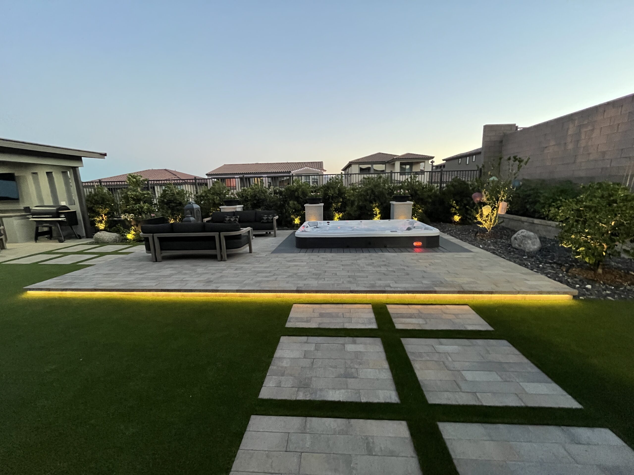 A view of an outdoor area with a pool and grass.