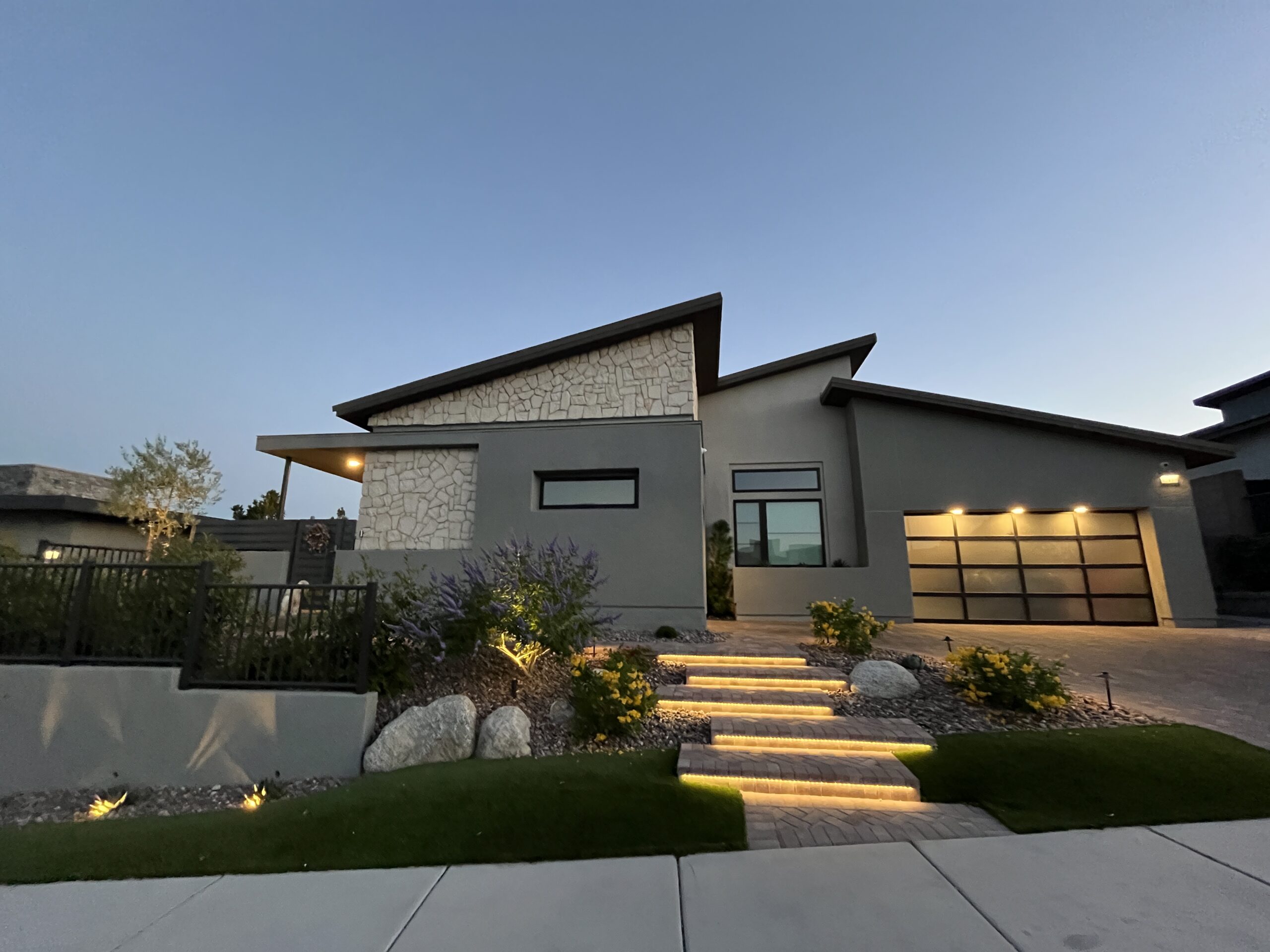 A modern house with steps leading to the front door.