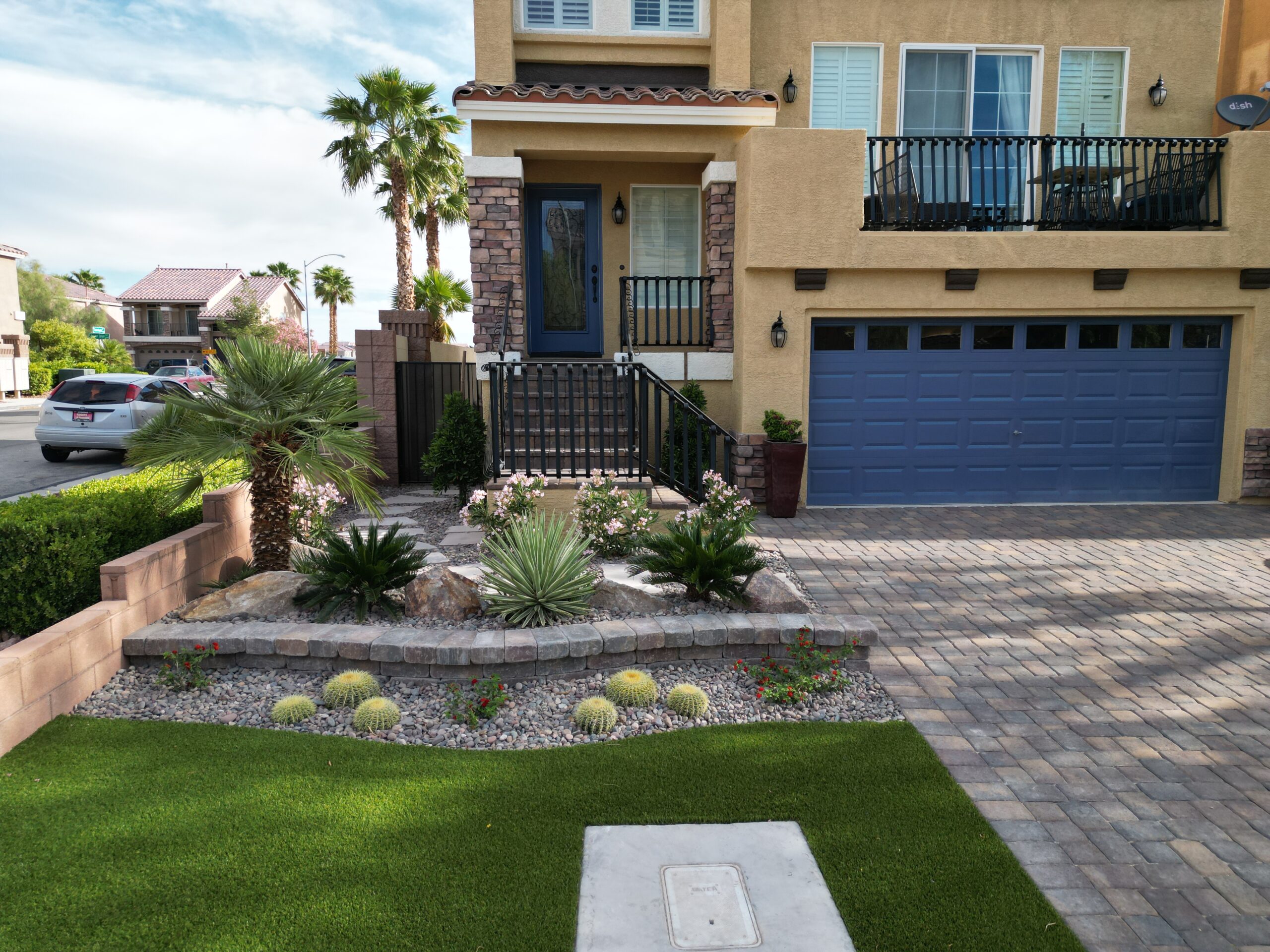 A house with a driveway and palm trees in the background.