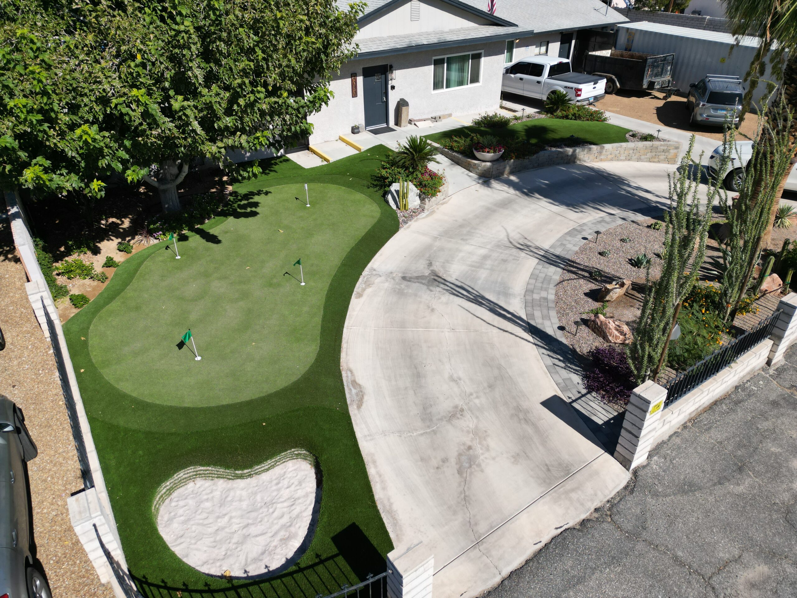 A view of a backyard with a putting green.