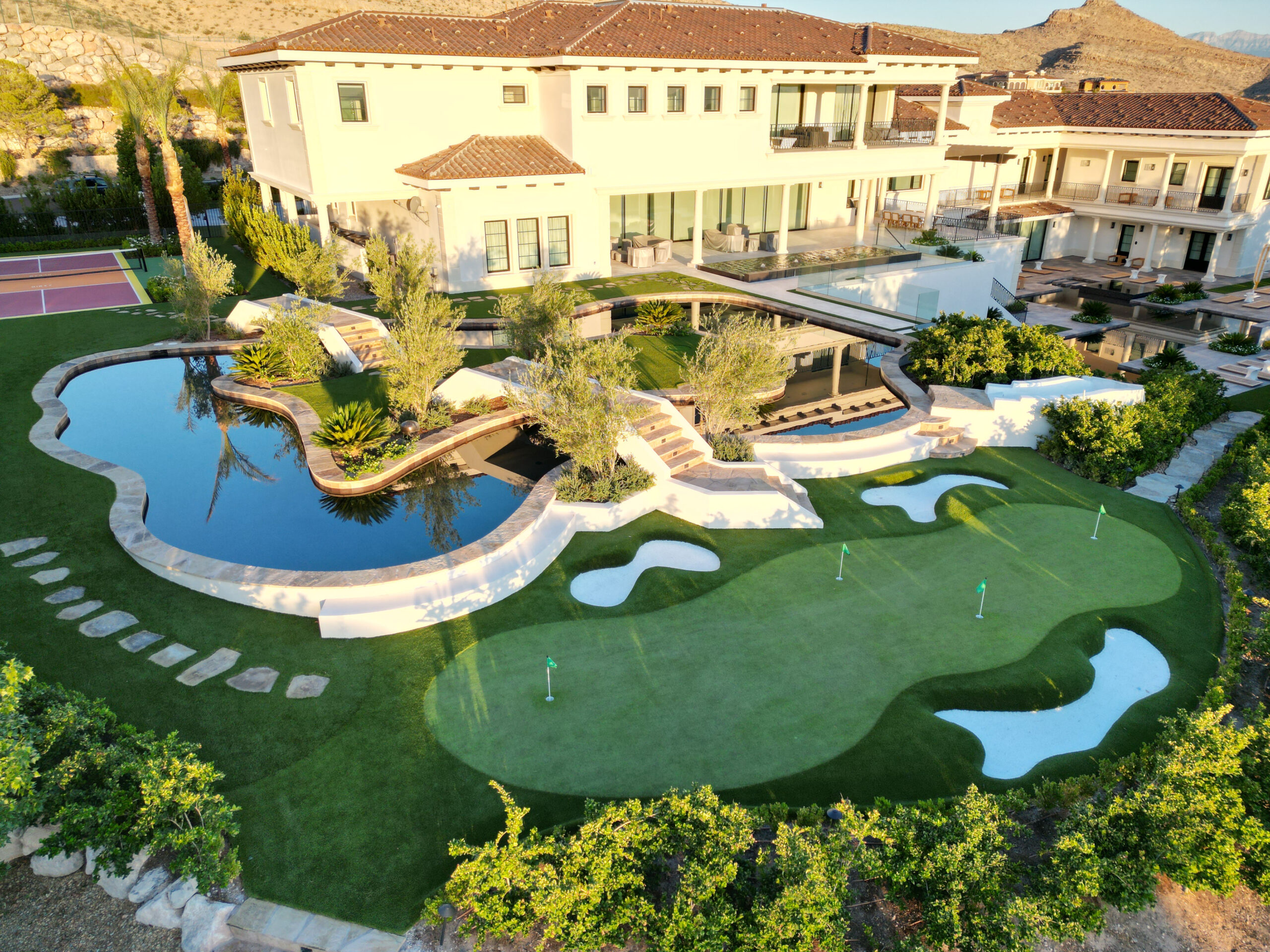 A large pool with a golf course in the middle of it.