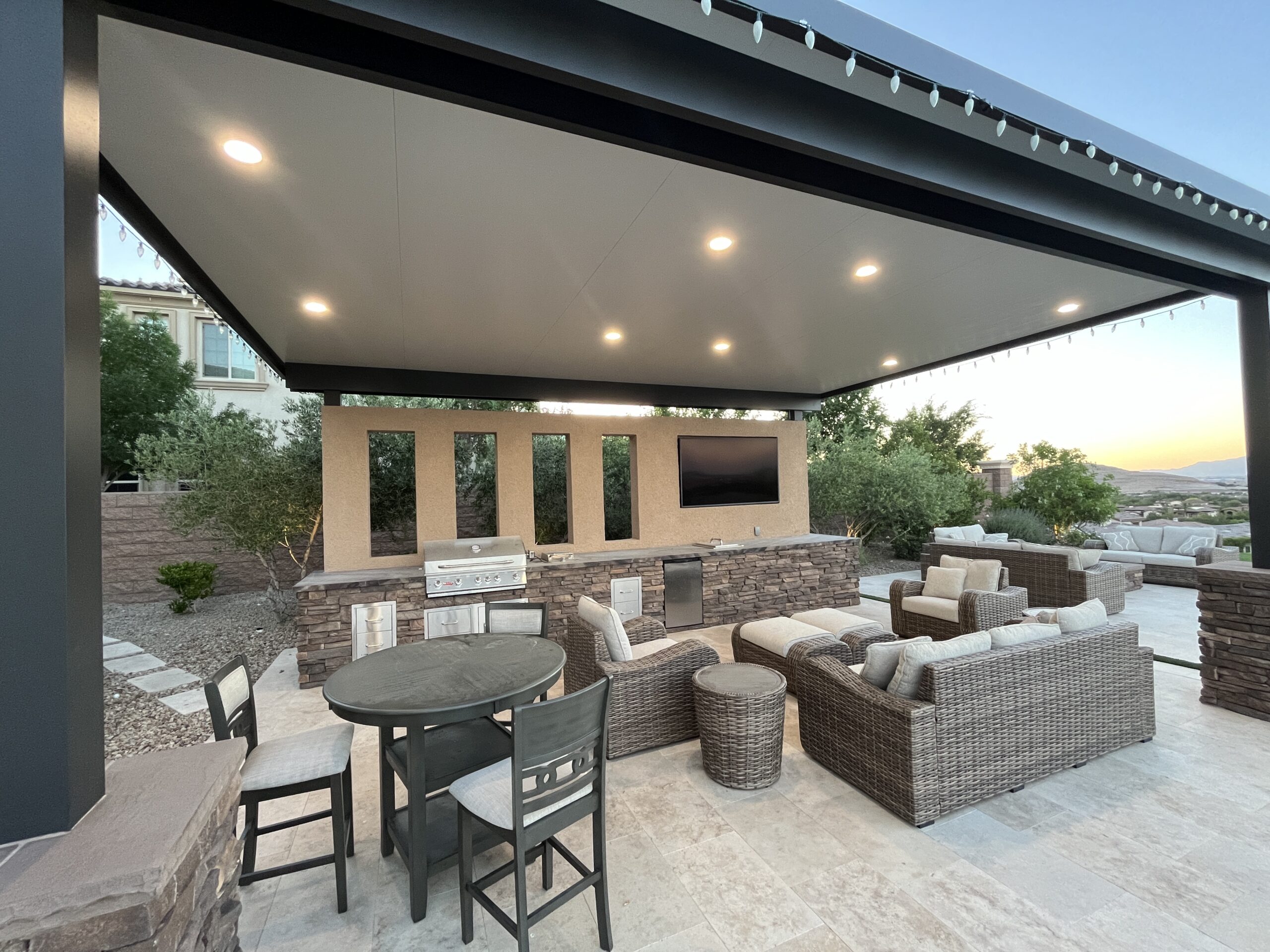 A patio with a couch, table and chairs.