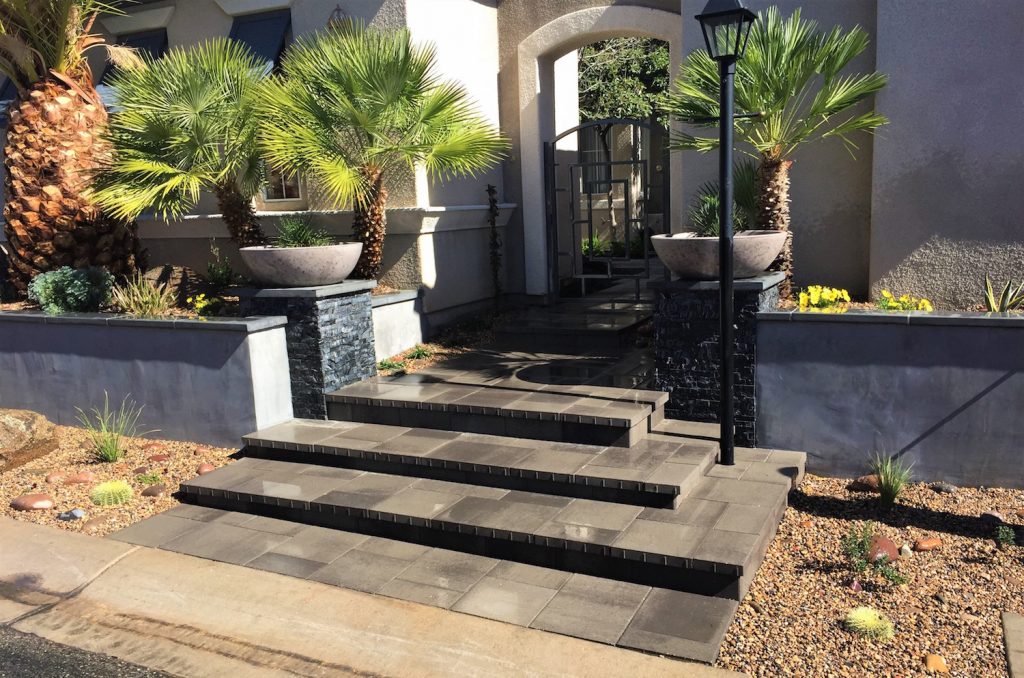 A front entrance with steps and planters.