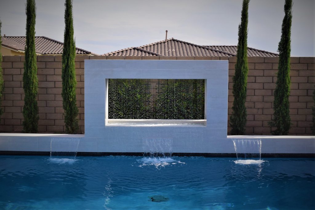 A pool with water jets and a wall